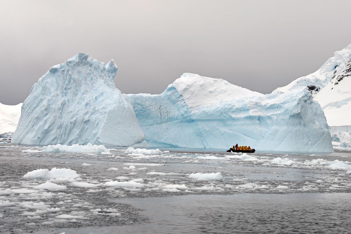 11B Zodiac Dwarfed By A Large Iceberg In Paradise Harbour On Quark Expeditions Antarctica Cruise